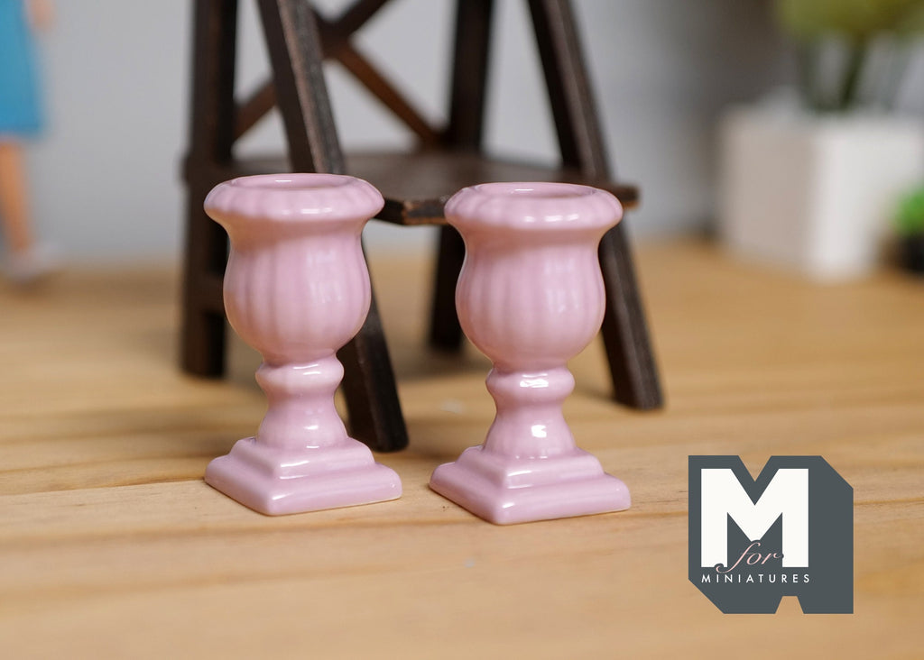 1:12 scale miniature pink Roman style pedestal urn planters with fluted bowls, set of 2, on a wood floor