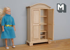 1:12 scale miniature arched top wardrobe in bare wood with 2 doors open showing shelves, shown beside a doll