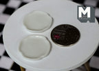 1:12 scale miniature ceramic scalloped plates in white, set of 2, shown on a round white table beside a coin