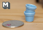 1:12 scale miniature ceramic round flower pots in light blue, small, set of 2, shown stacked beside a coin