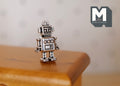 1:12 scale miniature metal retro robot figurine in antique silver, shown standing on a wood tabletop