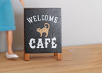 1:12 scale miniature cafe folding floor sign, black board with welcome cafe lettering and an orange cat drawing