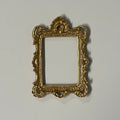 1:12 scale miniature ornate rectangular picture frame in gold with scrolled corners, shown empty on a white surface