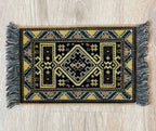 1:12 scale miniature large wool area rug with fringe in black and gold with a geometric medallion design
