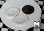 1:12 scale miniature ceramic oval plates in white, small, set of 2, shown beside a coin for scale on a white table
