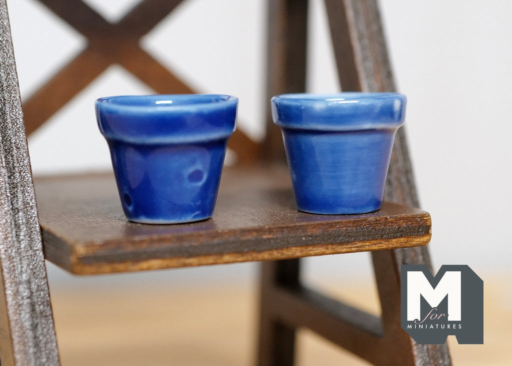 1:12 scale miniature cobalt blue ceramic flower pots with glossy glaze, set of 2, shown on a dark wood shelf