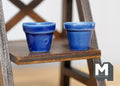 1:12 scale miniature cobalt blue ceramic flower pots with glossy glaze, set of 2, shown on a dark wood shelf