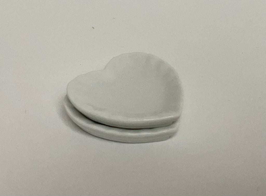 1:12 scale miniature white ceramic heart shaped plates, set of 2, shown stacked on a white surface
