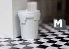 1:12 scale miniature white metal garbage can with lid and ribbed sides, shown on a black and white checkered floor