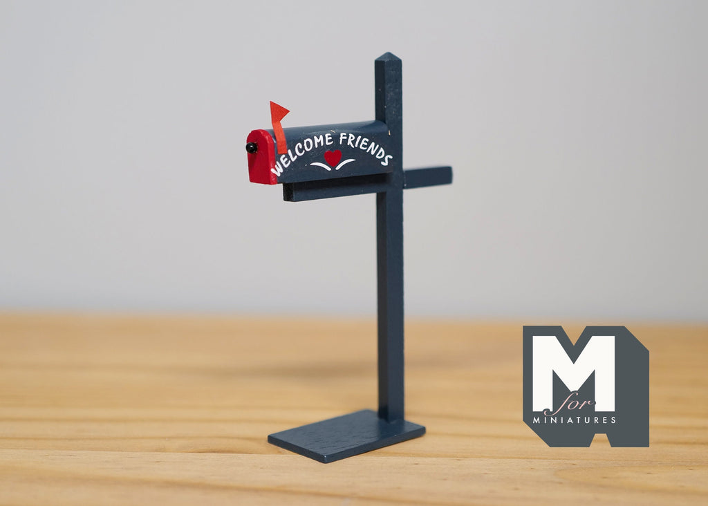 1:12 scale miniature wood mailbox on post in red and gray with fixed door and a welcome friends sign