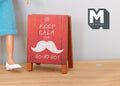 1:12 scale miniature wood Christmas A frame floor sign, double sided, red with white mustache print, on a wood floor
