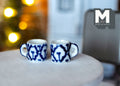 1:12 scale miniature ceramic coffee mugs with blue geometric pattern on white, set of 2, shown on a round white table