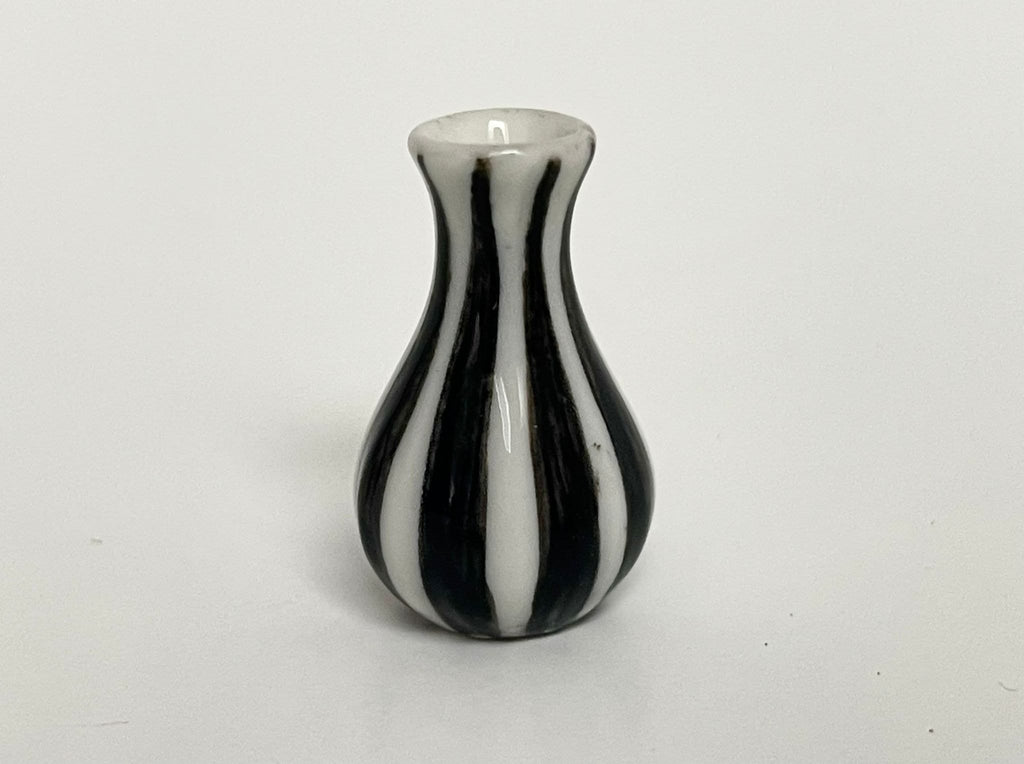 1:12 scale miniature ceramic flower vase with white and black vertical stripes and a flared neck, on a white surface