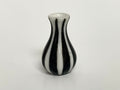 1:12 scale miniature ceramic flower vase with white and black vertical stripes and a flared neck, on a white surface