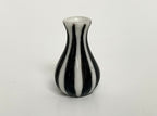 1:12 scale miniature ceramic flower vase with white and black vertical stripes and a flared neck, on a white surface