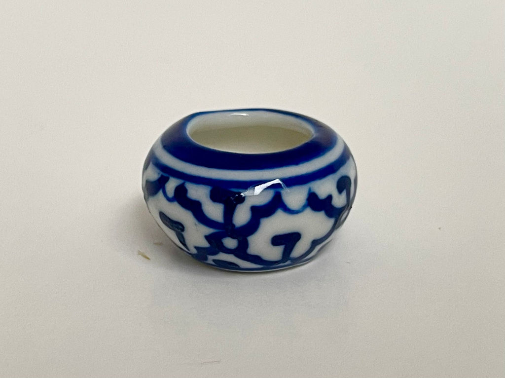 1:12 scale miniature ceramic flower pot, round with blue and white floral pattern, shown on a white surface