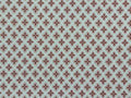 1:12 scale miniature red quatrefoil pattern wallpaper on white, with small red star motifs in a repeating lattice