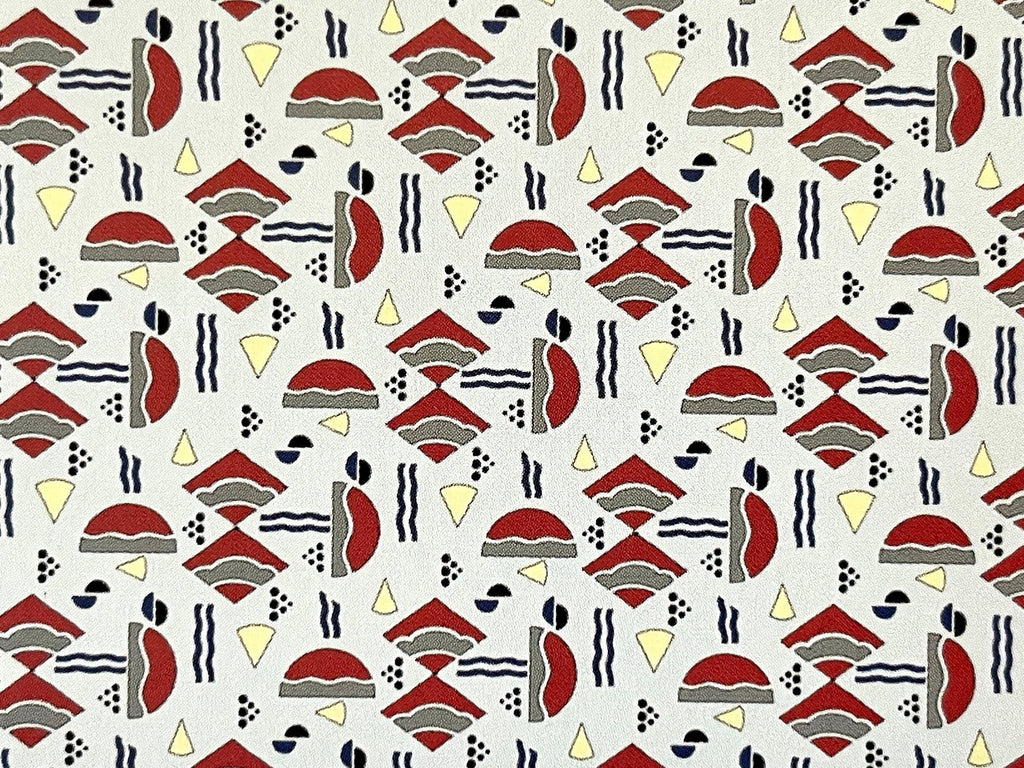 1:12 scale miniature geometric Odeon wallpaper with red, black and yellow Art Deco shapes on a cream background