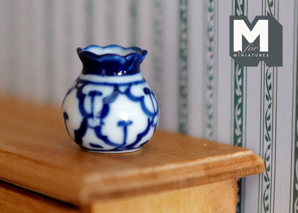 1:12 scale miniature ceramic round vase with flared lip, blue and white floral pattern, shown on a wood shelf