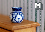 1:12 scale miniature ceramic round vase with flared lip, blue and white floral pattern, shown on a wood shelf