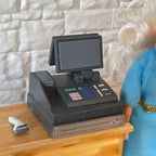 1:12 scale miniature cash register in black with 2 monitors and a barcode scanner, set of 2, on a wood shop counter