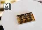 1:12 scale miniature Christmas gingerbread cookies on a silver baking tray, non edible, shown on a round white table