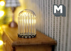 1:12 scale miniature medium ribbed glass dome on a black metal base, shown on a wood dresser with warm lights