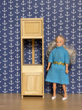 1:12 scale miniature wood oven cabinet kit, semi assembled tall unit with upper and lower doors, shown beside a doll