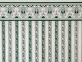 1:12 scale miniature Regency green stripe wallpaper on cream with a printed ornamental border along the top