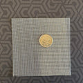 Square sheet of fine stainless steel wire mesh with a coin on top for size