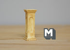 1:12 scale miniature garden pedestal plant stand in beige with a square column shape, shown on a wood table