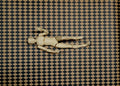 1:12 scale miniature black and tan harlequin diamond peel and stick flooring paper, shown with a wooden artist figure
