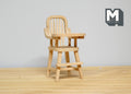 1:12 scale miniature unpainted wood high chair with tray and spindle back, shown on a wood floor against a white wall