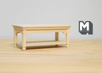 1:12 scale miniature unpainted wood coffee table with lower shelf and turned legs, shown on a wood surface
