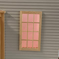 1:12 scale miniature unpainted 12 pane window with back trim and acrylic pane, shown installed in gray siding