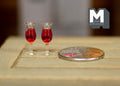 1:12 scale miniature glasses of red wine, set of 2, short stemmed tulip glasses, on a wood table beside a coin