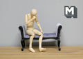 1:12 scale miniature upholstered chaise bench in lavender fabric with black carved wood frame, shown with a seated figure