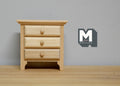 1:12 scale miniature unpainted wood nightstand with 3 drawers and round knobs, shown against a gray wall