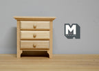 1:12 scale miniature unpainted wood nightstand with 3 drawers and round knobs, shown against a gray wall