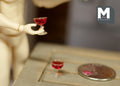 1:12 scale miniature glasses of red wine, set of 2, wide coupe style glasses, shown with a jointed figure and a coin