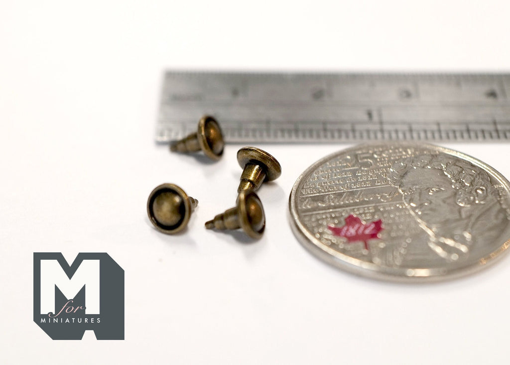 1:12 scale miniature antique brass round cabinet knobs, set of 4, shown with a coin and a ruler for scale