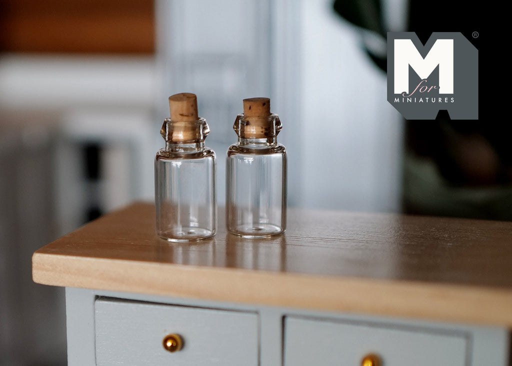 1:12 scale miniature clear glass bottles with cork stoppers, set of 2, shown on a kitchen counter