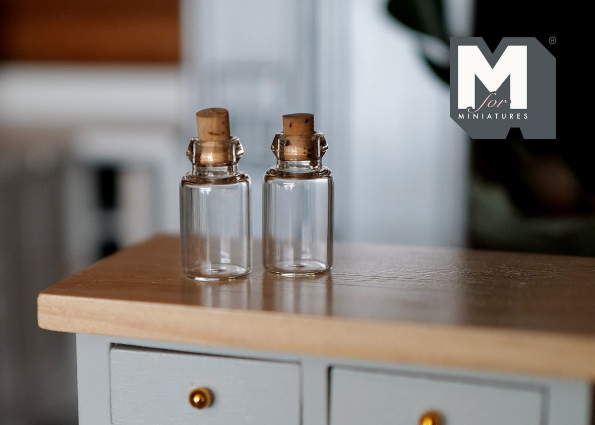1:12 scale miniature clear glass bottles with cork stoppers, set of 2, shown on a kitchen counter
