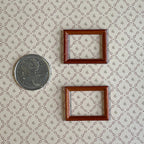1:12 scale miniature rectangular picture frames in mahogany, set of 2, empty, shown beside a coin for scale