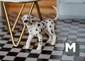 1:12 scale miniature standing Dalmatian dog in white with black spots, shown on a black and white checkered floor
