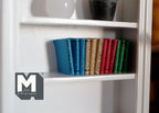 1:12 scale miniature hardcover books in assorted colors, set of 12, small size, lined up on a white bookshelf