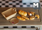 1:12 scale miniature bread basket with 7 breads, set of 8, baguette, croissants and rolls shown beside a coin