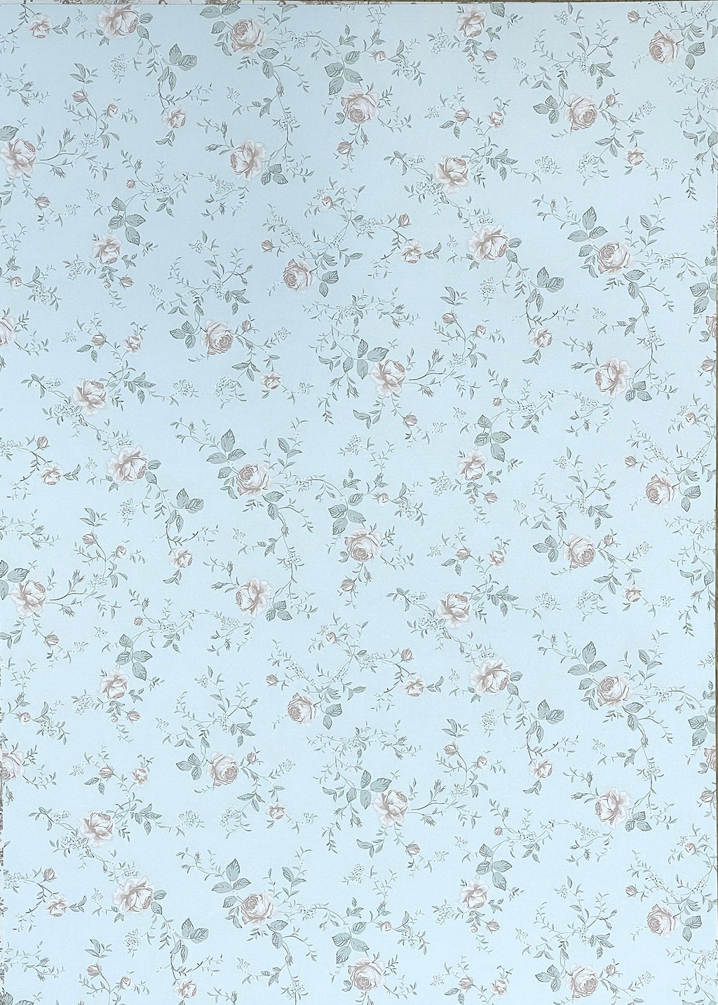 1:12 scale miniature floral peel and stick wallpaper in light blue with small pink roses and green leaves