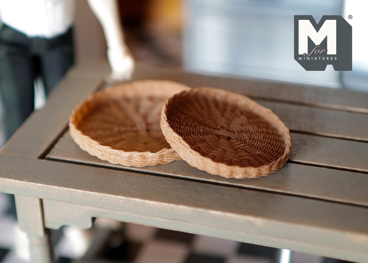 1:12 scale miniature brown round woven trays, set of 2, shallow basket style, shown on a gray wood table