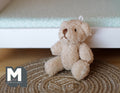 1:12 scale miniature velvet plush teddy bear in beige with jointed arms and legs, sitting on a woven rug